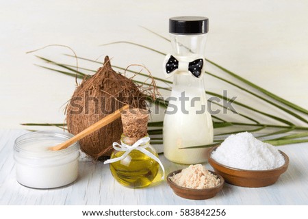 Various coconut products set on white wooden background