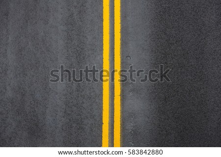 Yellow double solid line. Road markings on asphalt on the street of Manhattan in New York City Royalty-Free Stock Photo #583842880