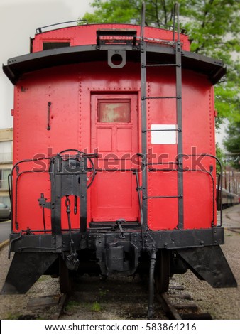 Bright red caboose at the rear of a train on display in Chattanooga, Tennessee Royalty-Free Stock Photo #583864216