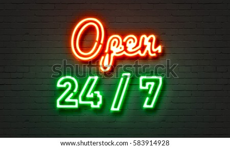 Open 24/7 neon sign on brick wall background
