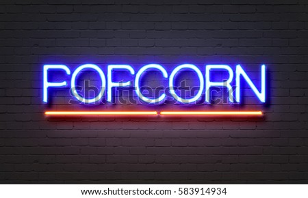 Popcorn neon sign on brick wall background