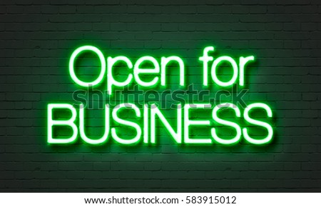 Open for business neon sign on brick wall background