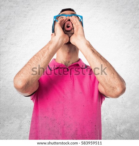 Man with colorful clothes shouting on grey textured background
