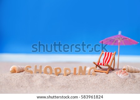 Summer holiday decoration with wooden text, beach chair and sea shall on white sand beach with tropical blue sea and clear blue sky,Image For Love shopping  summer holiday vacation travel Concept.