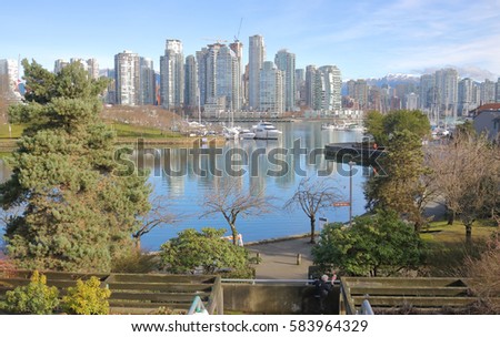 A high angle view of False Creeks's inner harbor and the rising Vancouver skyline/False Creek Inner Harbor and Vancouver Skyline/A view of False Creeks inner harbor and the rising Vancouver skyline. 