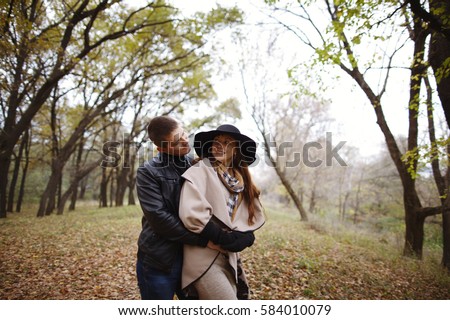 Beautiful stylish and sweet couple in a relationship. Very loving couple enjoying the outdoors. Happy lovers walk in the woods