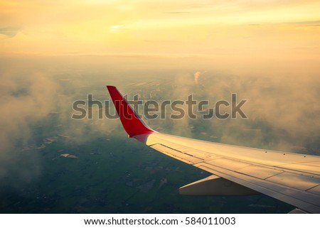 Vintage color tone of Morning sunrise with Wing of an airplane. Photo applied to tourism operators. picture for add text message or frame website. Traveling concept