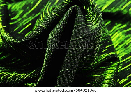 Green Shiny elastic stretch dress material cloth texture pattern. 
tailoring stitching concept. Shiny beautiful fashion fabric. Shiny clothing material sample.Creased fabric.