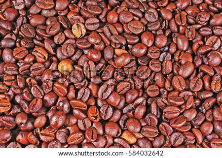 Coffee texture. Roasted coffee beans as background wallpaper. Beautiful arabica real cofee bean illustration for any concept. Gourmet coffee beans macro closeup studio photo. 