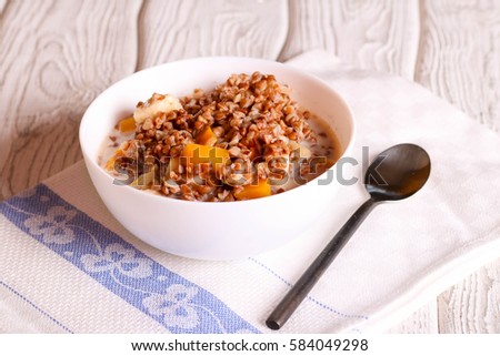 Buckwheat porridge with pumpkin, banana and Apple, close up, horizontal