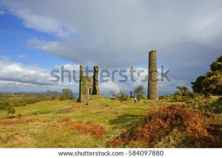 A partial winter rainbow over the abandoned ruins of the Wheal Jenkins Engine house, Bodmin Moor, Cornwall, UK