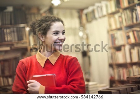 Joyful woman holding a book
