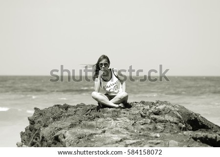 I sit on the rocks overlooking the beautiful sea in Thailand