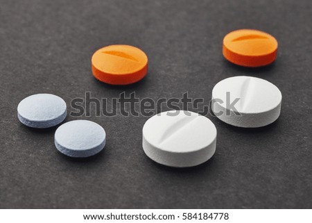 Pills over a black background. Medicament treatment. Health care photo