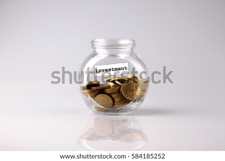 Savings concept: a glass jar with the word INVESTMENT coin Malaysia