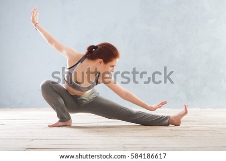 Young Woman praticing tai chi chuan in the gym. Chinese management skill Qi's energy. Royalty-Free Stock Photo #584186617