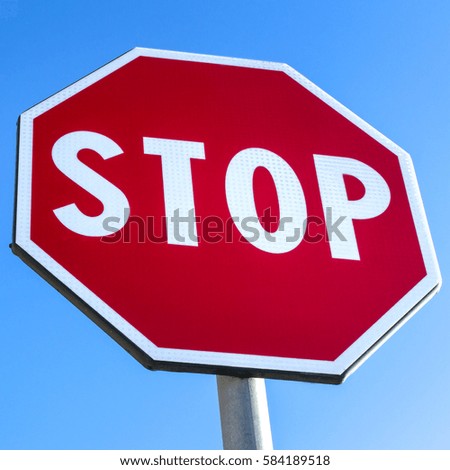 Red traffic sign isolated on clear blue sky
