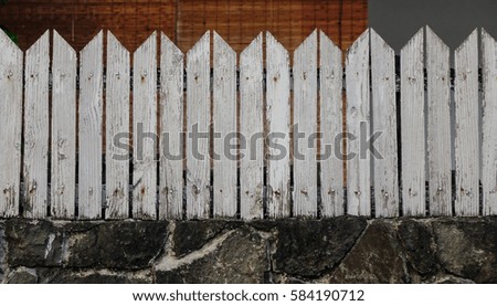 Wooden fence with stone wall at the ancient building in Grand Baie, Mauritius.