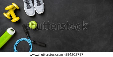Fitness equipment on a dark background with copy space Royalty-Free Stock Photo #584202787