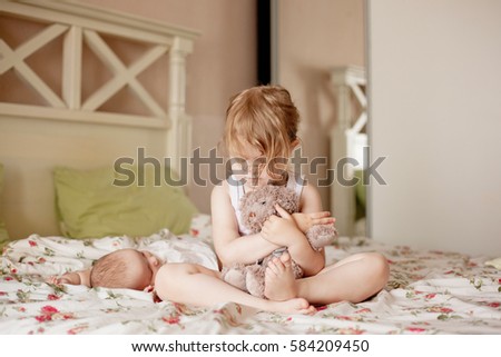 little girl woke up and hugging her teddy bear