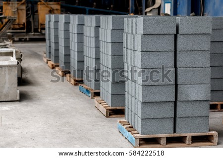 Concrete blocks on wooden pallets before loading Royalty-Free Stock Photo #584222518