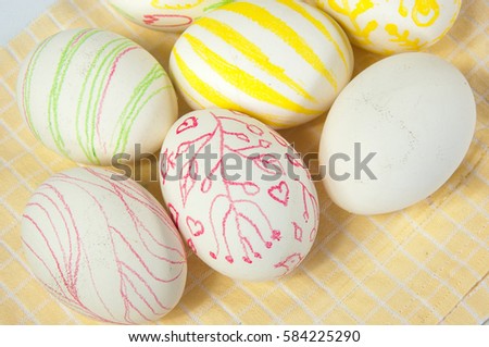 Closeup of beautiful Easter eggs with their hands. A festive mood