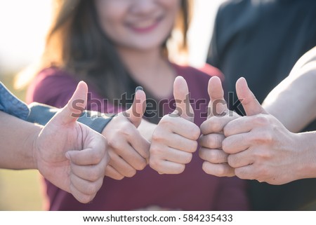 Good of young positive thinking people community join and combine giving hands with thumbs up  together expressing positivity, teamwork concepts. Royalty-Free Stock Photo #584235433