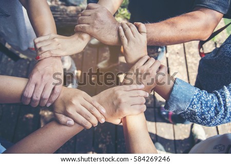 Customer Loyalty Team. Trustworthy diversity business Team positive motivated with hands together. Trust helping unified communications with loyalty customers and other. Communication Concept. Royalty-Free Stock Photo #584269246
