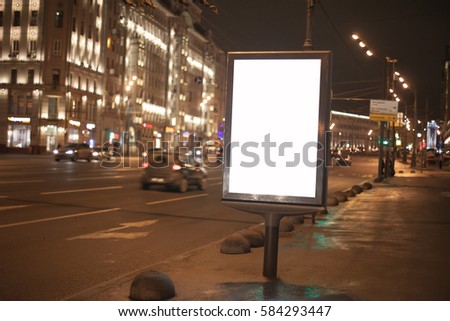 Blank billboard with copy space area for your text message or promotional content next to road in night