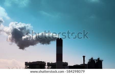 Smoke comes out of factory chimneys / environment and industry and air pollution, dust, smog, fine dust Royalty-Free Stock Photo #584298079