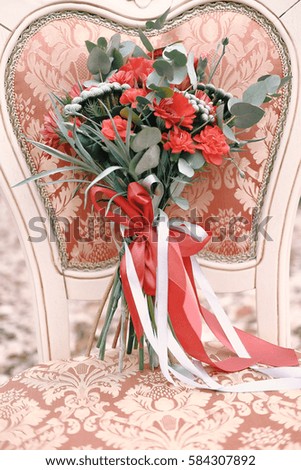 Wedding bouquet lying on the chair among autumn forest