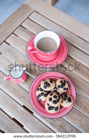 Chocolate chips cookies with milk and coffee on wooden table