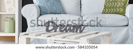 Wooden coffee table with the dream sign on it
