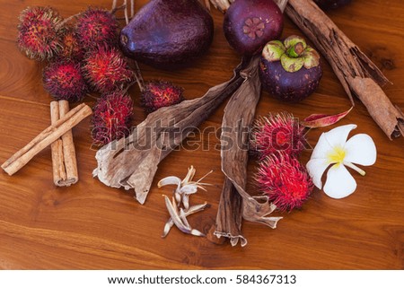 Tropical fruits on wooden table, top view