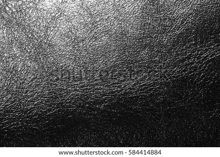 black leather texture as a background reflecting light