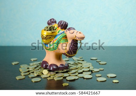 A rubber toy of camel side view and coins. money box