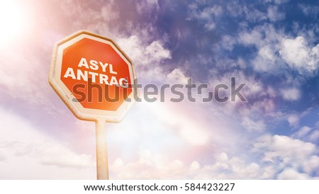 Asylantrag (German for asylum request) on red traffic road stop sign in front of blue sky with clouds and friendly sun beams, digital composing with light leaks and flares