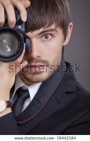 male photographer in business suit taking a picture