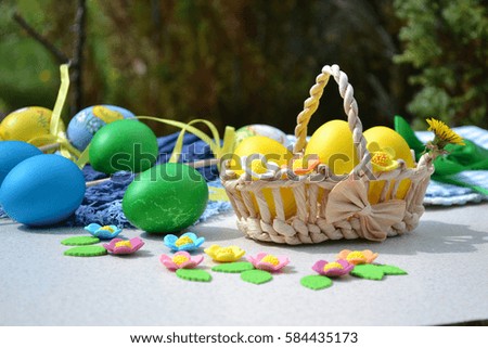 Easter eggs and sweet decor on outdoor background. Preparations for the holiday