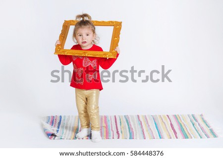Portrait of a cute little girl with decoration picture frame