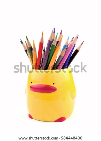 Many color pencils in cute ceramics cup or box isolated on the white background, front view.