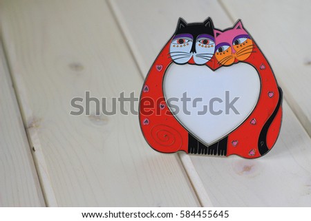 
Frame in the form of a pair of cats on a light background