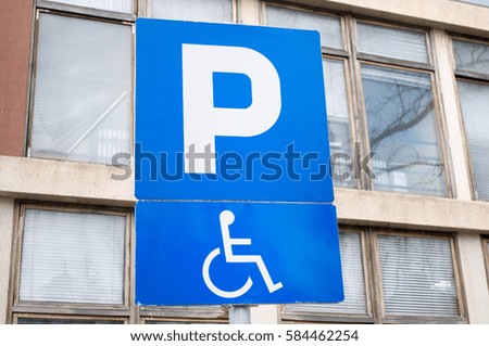 Traffic sign indicating a parking place and a place for people with disabilities with cars, Novi Sad, Serbia
