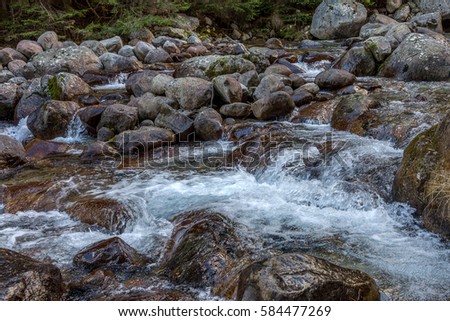 Beautiful bright contrasting mountain landscape. The mountain river flows fast through the mountain rocks, forming waterfalls and a lot of spray. Balkan Mountains, Bulgaria, Europe