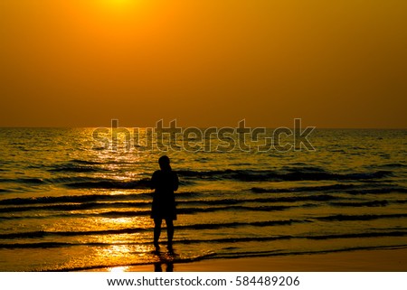 Siluate lovers and beach before sunset background