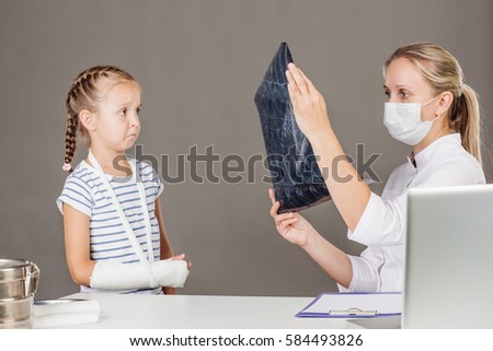 Young female doctor looking at the x-ray picture. medicine, health care and people concept