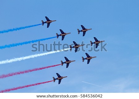Jet aircrafts aerobatic group of French Air Force drawing french flag figure in the sky, during Le Bourget Paris air show Royalty-Free Stock Photo #584536042