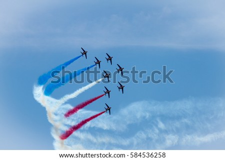 The Patrouille de France aerobatic demonstration team of the French Air Force making flag figure of colred smoke traces in the sky during Le Bourget Paris air show Royalty-Free Stock Photo #584536258