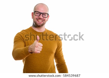 Young happy bald muscular man smiling while giving thumb up