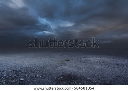 Surreal gravel dark background with dramatic sky Royalty-Free Stock Photo #584581054